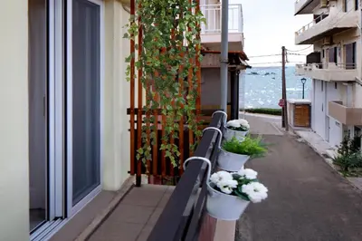 a row of potted plants on a railing on a balcony at Casa Gardenia-modern apartment next to the beach, near Old Town in Chania Town