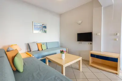a living room with a couch and a table at Anna Αpartments II in Agia Marina Nea Kydonias
