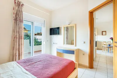 a bedroom with a bed and a view of a room at Anna Αpartments II in Agia Marina Nea Kydonias