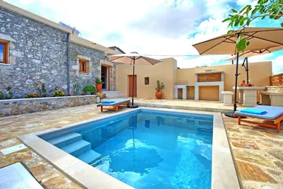 a swimming pool in the backyard of a house at Villa Vicilla by PosarelliVillas in Fílippos