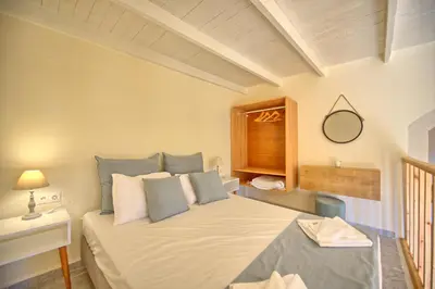 a bedroom with a bed and a mirror and a window at Villa Vicilla by PosarelliVillas in Fílippos