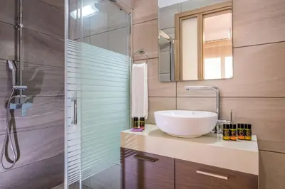 a bathroom with a sink and a glass shower at Park View and near the Sea Villa with Private Pool 1 in Chania Town