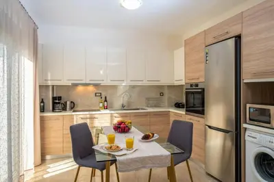 a kitchen with a table and chairs with orange juice at Park View and near the Sea Villa with Private Pool 1 in Chania Town