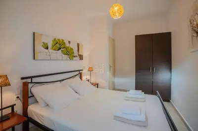 a bedroom with a bed with two towels on it at Villa Marianne in Chania Town