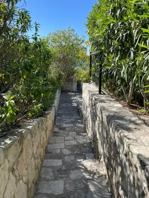 a stone path next to a stone wall at Villa Marianne in Chania Town