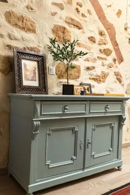 a gray cabinet with a potted plant on top at Beit Petra in Daratso