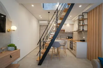 a kitchen with a staircase leading up to a loft at Mezoneta 