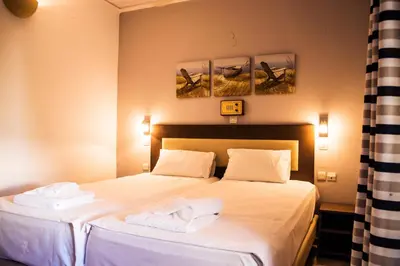 a bedroom with a bed with two towels on it at Polydoros Hotel Apartments in Palaiochóra