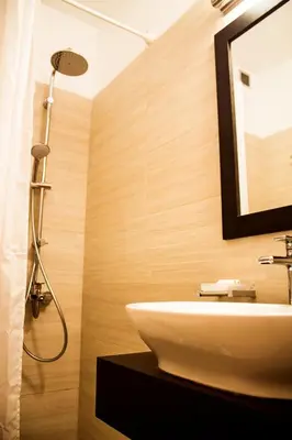 a bathroom with a sink and a shower at Polydoros Hotel Apartments in Palaiochóra