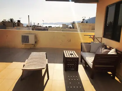 a living room with a couch and a table at Polydoros Hotel Apartments in Palaiochóra