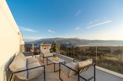 a balcony with chairs and a table and a view at Villa Jarko in Chania Town