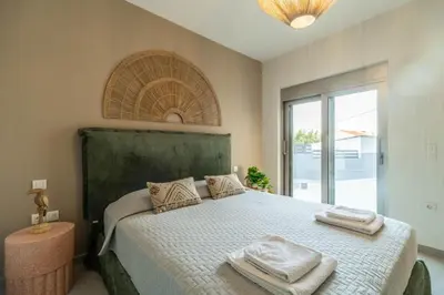 a bedroom with a large bed with towels on it at Villa Jarko in Chania Town