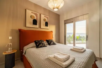 a bedroom with a bed with two towels on it at Villa Jarko in Chania Town