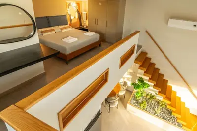 a room with a staircase and a bed and a mirror at Villa Jarko in Chania Town