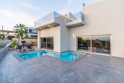 a house with a swimming pool in front of it at Villa Jarko in Chania Town