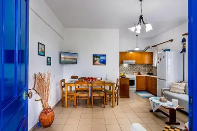 a kitchen and dining room with a table and chairs at Blue Beach House in Kissamos