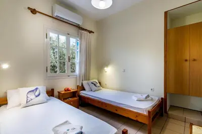 a room with two beds and a window at Blue Beach House in Kissamos