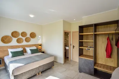 a bedroom with a large bed and a closet at Ilingas Mare in Khóra Sfakíon