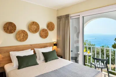 a bedroom with a bed and a balcony at Ilingas Mare in Khóra Sfakíon