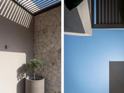 a house with a potted plant in a room at Athina Luxury Villa, with Pool & Walk to the Beach, By ThinkVilla in Chania Town