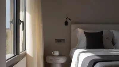 a bedroom with a bed and a window with a candle on it at Athina Luxury Villa, with Pool & Walk to the Beach, By ThinkVilla in Chania Town