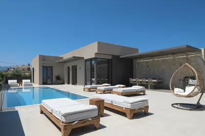 a villa with a swimming pool and a house at Athina Luxury Villa, with Pool & Walk to the Beach, By ThinkVilla in Chania Town