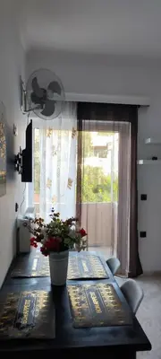a dining room table with a potted plant on it at Chania City Apartments in Chania Town