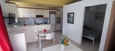 a small kitchen with a table and chairs and a bed at Chania City Apartments in Chania Town