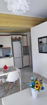 a kitchen with a table and a table and flowers at Chania City Apartments in Chania Town