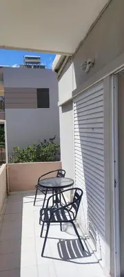 a table and chairs on the balcony of a house at Chania City Apartments in Chania Town