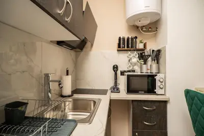 a small kitchen with a sink and a microwave at welcome Dream home in Chania Town