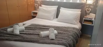 a bedroom with a bed with rolled towels on it at welcome Dream home in Chania Town