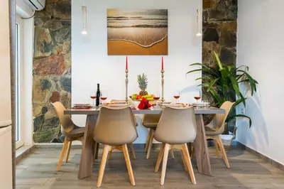 a dining room with a wooden table and chairs at Vista Magica in Chania Town