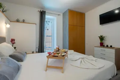 a bedroom with a bed with a tray of food on it at Vista Magica in Chania Town
