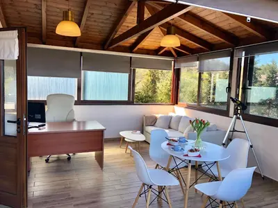 a living room with a couch and a table and chairs at Zafeiria's Suite in Vamos