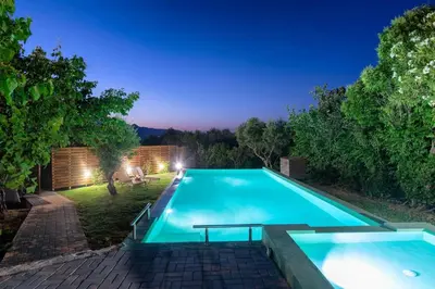 a swimming pool in a backyard at night at Majestic Villa in Chania Town
