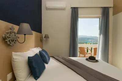 a bedroom with a bed with a hat on it at Majestic Villa in Chania Town