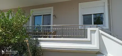 a balcony of a house with a bench on it at Happiness Luxury Home in Palaiochóra