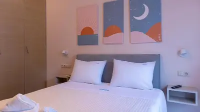 a bedroom with a bed with two white pillows at Happiness Luxury Home in Palaiochóra