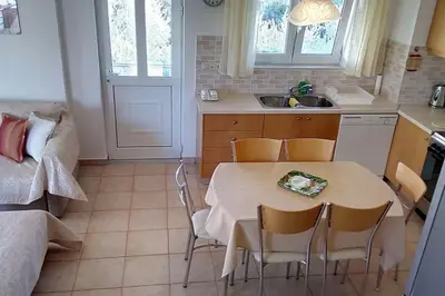 a kitchen with a table and chairs in a room at Roof-Garden Apartment in Chania Town