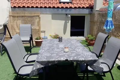 a table and chairs with a table cloth on a patio at Roof-Garden Apartment in Chania Town