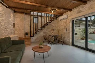 a living room with a couch and a table at Villa Magnolia in Ayiá