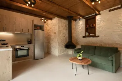 a kitchen with a couch and a table in a room at Villa Magnolia in Ayiá