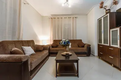 a living room with two couches and a coffee table at Lazaretta apartment in Chania Town