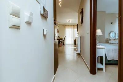 a hallway leading to a bedroom and a living room at Lazaretta apartment in Chania Town