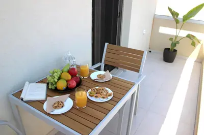 a table with food and drinks and fruit on it at New Cozy Chic Apt-Ryfete Luxury Living in Kalathas