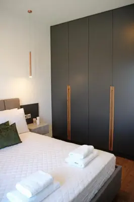 a bedroom with a bed with towels on it at New Cozy Chic Apt-Ryfete Luxury Living in Kalathas