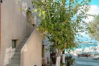 a staircase next to a building with a tree at Fragios Beach House in Chania Town