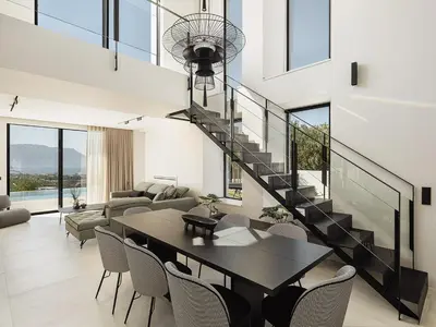 a living room with a table and a staircase at Villas Phos and Kallos in Kissamos