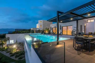 a house with a swimming pool at night at Villas Phos and Kallos in Kissamos